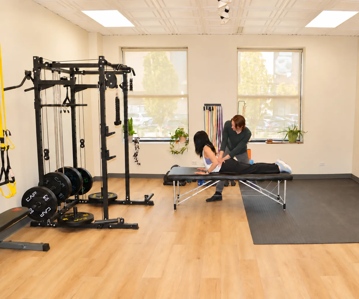 Clinician guiding a patient through a stretch on a treatment table at Form and Function in Lincoln Park, Chicago